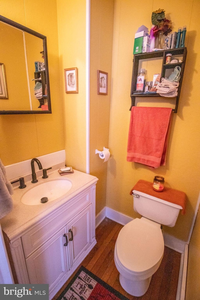 606 Ridgley St, Orbisonia, PA 17243 - half bathroom featuring toilet, wood finished floors, baseboards, and vanity