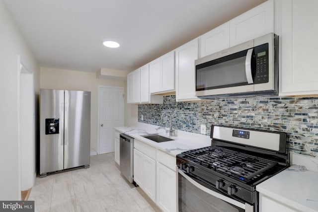 1666 Thetford Rd, Baltimore, MD 21286 - kitchen with decorative backsplash, a sink, white cabinetry, and appliances with stainless steel finishes