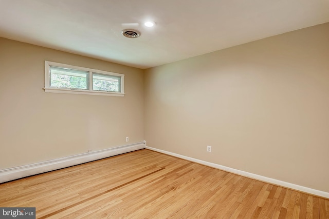 8601 Warfield Rd, Gaithersburg, MD 20882 - unfurnished room with baseboards, a baseboard heating unit, visible vents, and light wood-style floors