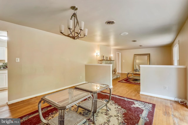 8601 Warfield Rd, Gaithersburg, MD 20882 - dining space featuring visible vents, light wood finished floors, baseboards, and a chandelier