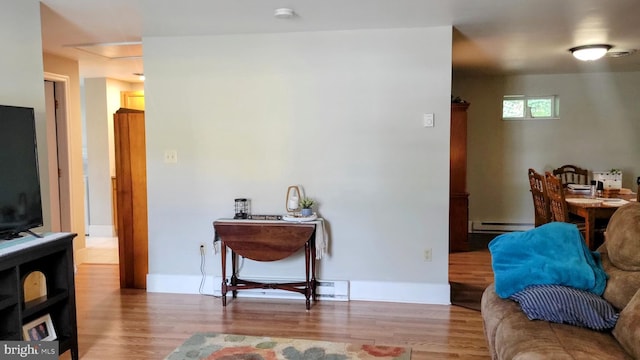 27 W Sixth St, Waynesboro, PA 17268 - living area featuring a baseboard heating unit, wood finished floors, and baseboards
