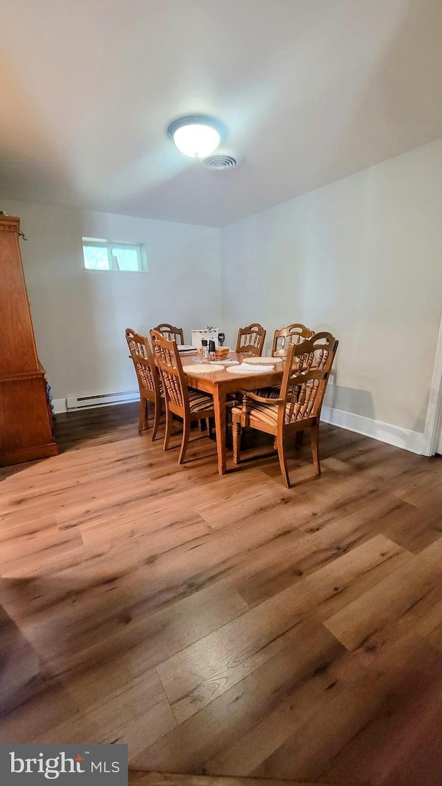 27 W Sixth St, Waynesboro, PA 17268 - dining room with light wood finished floors, baseboards, and a baseboard radiator