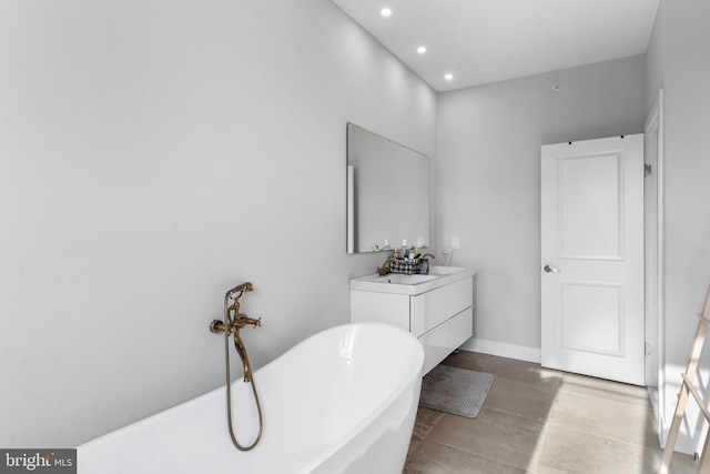 2714 W Jefferson St, Philadelphia, PA 19121 - bathroom featuring a soaking tub, recessed lighting, vanity, and baseboards