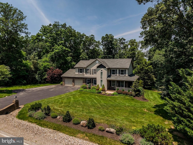 61 Sedgwick Dr, East Berlin, PA 17316 - view of front facade with asphalt driveway, covered porch, a front lawn, and an attached garage