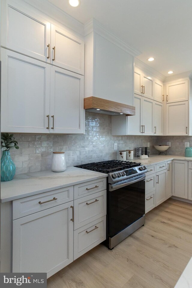 kitchen featuring white cabinetry, light wood-style flooring, and stainless steel gas stove