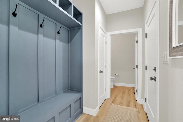 mudroom featuring light wood-style flooring and baseboards