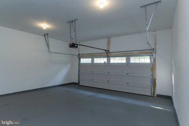 garage with a garage door opener and baseboards