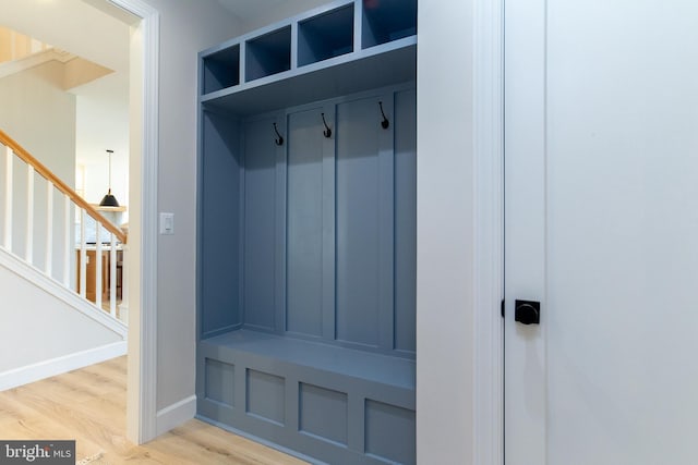 mudroom with baseboards and light wood-style flooring