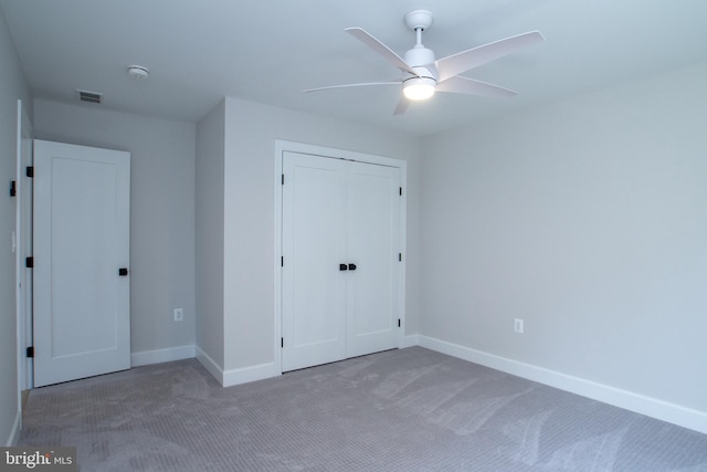 unfurnished bedroom featuring a ceiling fan, carpet, visible vents, baseboards, and a closet