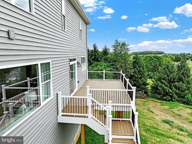 wooden terrace with a yard and stairs
