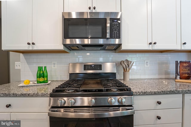 427 Whispering Elm Ln, Millersville, MD 21108 - kitchen featuring appliances with stainless steel finishes, white cabinetry, light stone counters, and backsplash