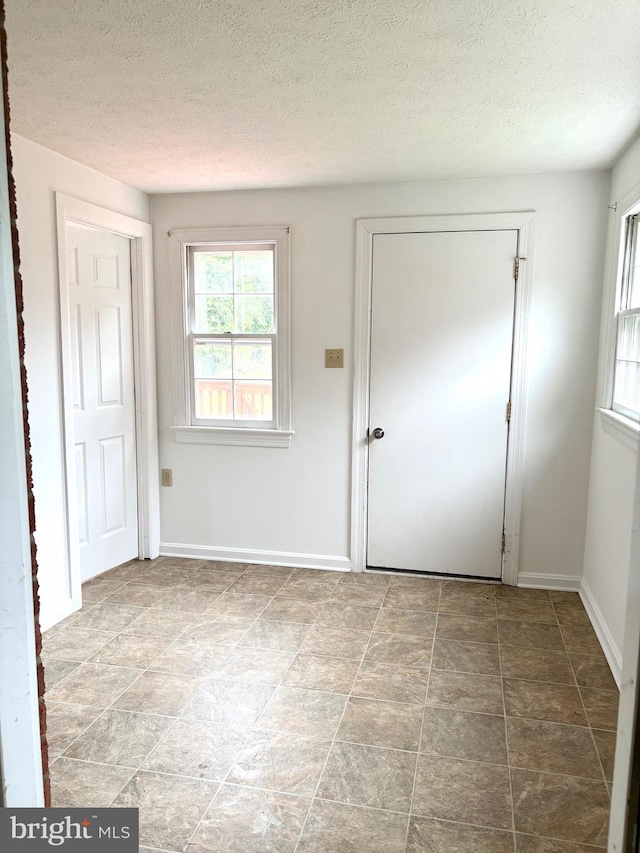 205 Parkway St, Winchester, VA 22601 - doorway with a textured ceiling and baseboards