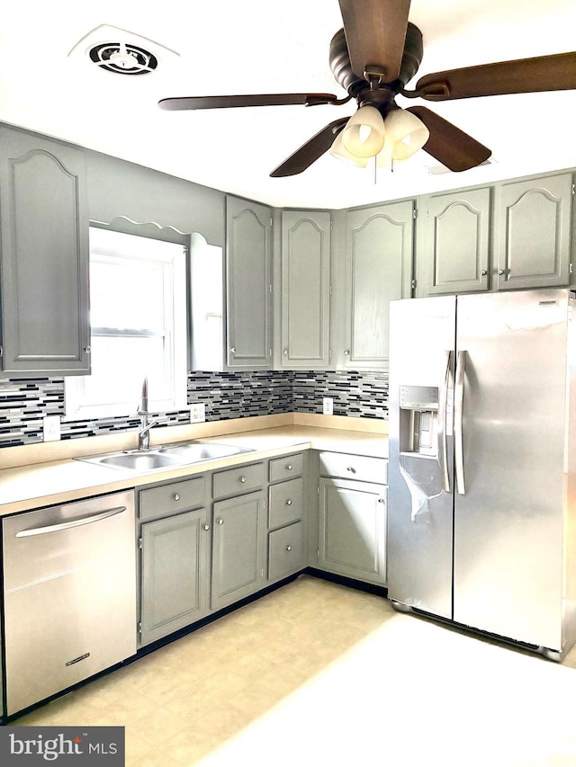 205 Parkway St, Winchester, VA 22601 - kitchen featuring appliances with stainless steel finishes, a sink, ceiling fan, decorative backsplash, and light countertops