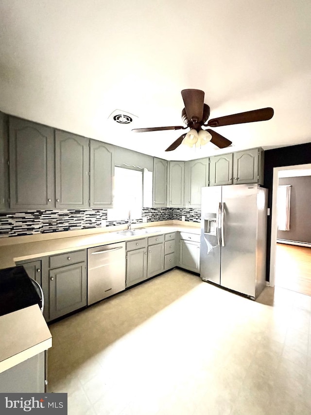 205 Parkway St, Winchester, VA 22601 - kitchen with appliances with stainless steel finishes, a sink, a ceiling fan, tasteful backsplash, and light countertops