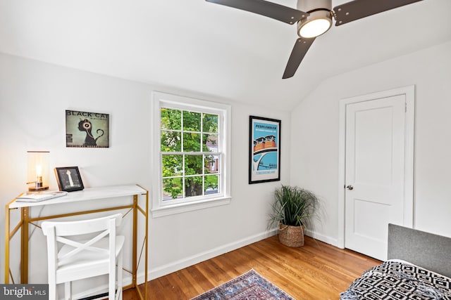 living area with lofted ceiling, light wood-style floors, baseboards, and ceiling fan