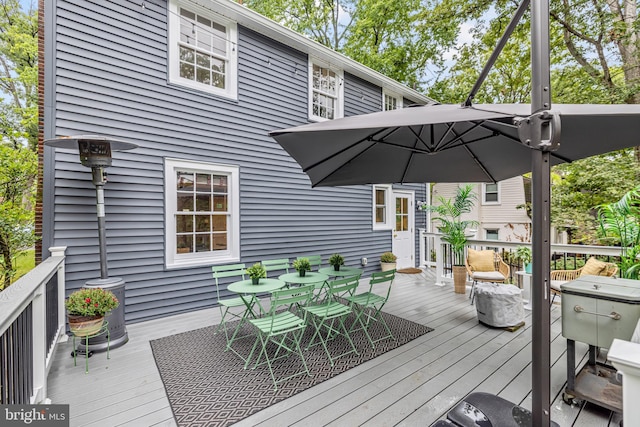 wooden deck featuring outdoor dining space