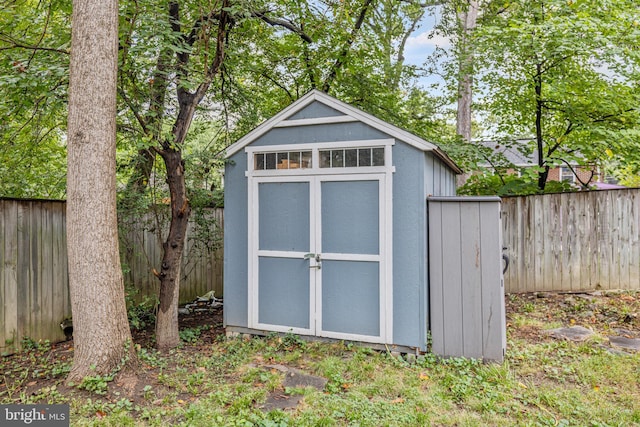 view of shed with a fenced backyard