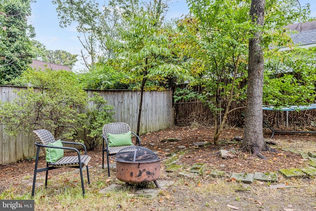 view of yard with a fenced backyard and an outdoor fire pit