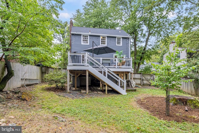 back of property featuring stairway, a wooden deck, a chimney, a fenced backyard, and a gate