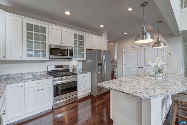 kitchen with light stone counters, dark wood-style floors, recessed lighting, appliances with stainless steel finishes, and white cabinets
