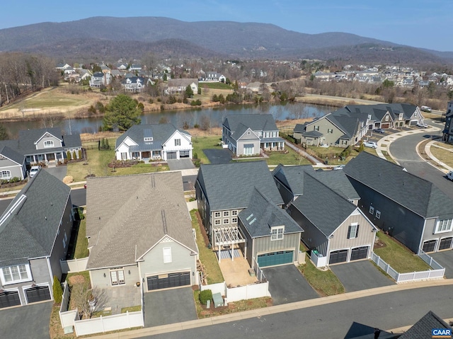 bird's eye view with a residential view and a water and mountain view