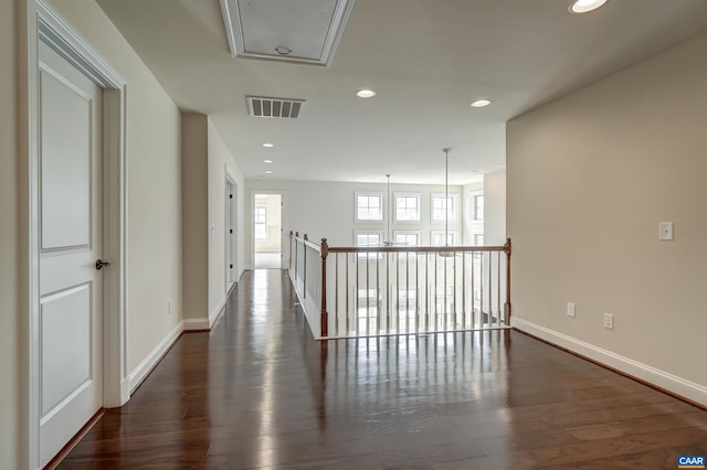 corridor featuring recessed lighting, visible vents, attic access, and wood finished floors