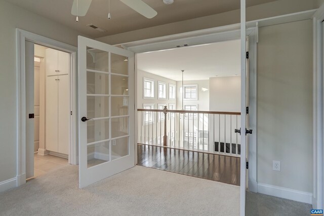carpeted empty room featuring visible vents, french doors, baseboards, and ceiling fan