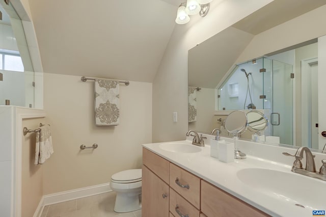 bathroom with a sink, toilet, a shower stall, and vaulted ceiling