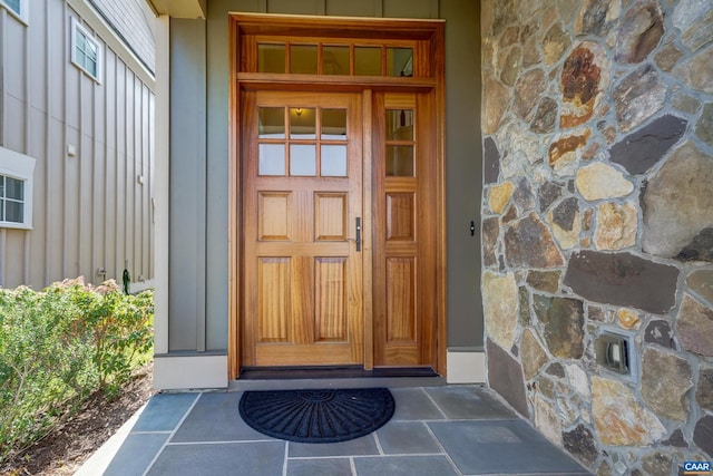 property entrance featuring stone siding