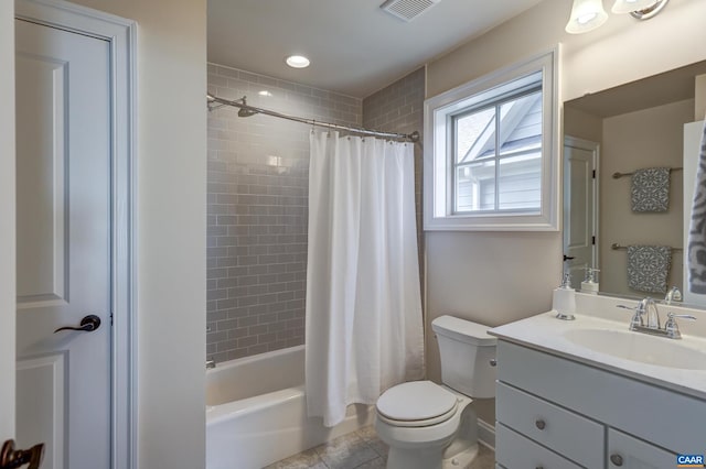 bathroom with vanity, visible vents, shower / bath combo with shower curtain, tile patterned floors, and toilet