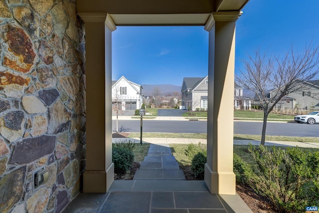 view of patio / terrace with a residential view and a porch