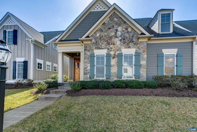 view of front of house featuring stone siding and a front lawn