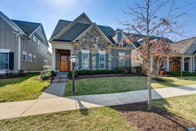 view of front of property featuring stone siding and a front lawn