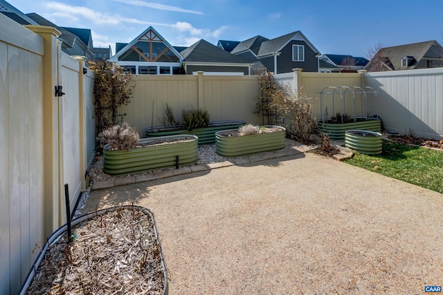 view of patio / terrace with a garden and a fenced backyard