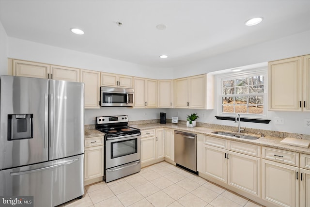 8801 Temple Hill Rd, Clinton, MD 20735 - kitchen featuring a sink, stainless steel appliances, cream cabinets, and recessed lighting