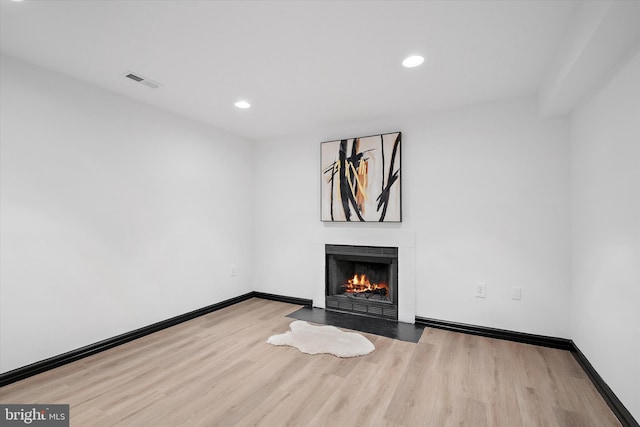 8801 Temple Hill Rd, Clinton, MD 20735 - unfurnished living room featuring a fireplace with flush hearth, baseboards, visible vents, and wood finished floors