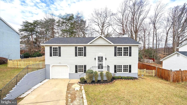 8801 Temple Hill Rd, Clinton, MD 20735 - split foyer home featuring an attached garage, concrete driveway, a front lawn, and fence