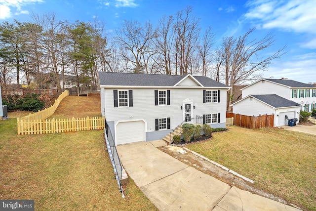 8801 Temple Hill Rd, Clinton, MD 20735 - split foyer home with concrete driveway, an attached garage, fence, and a front yard