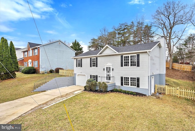 8801 Temple Hill Rd, Clinton, MD 20735 - raised ranch featuring a front lawn, fence, concrete driveway, a chimney, and a garage