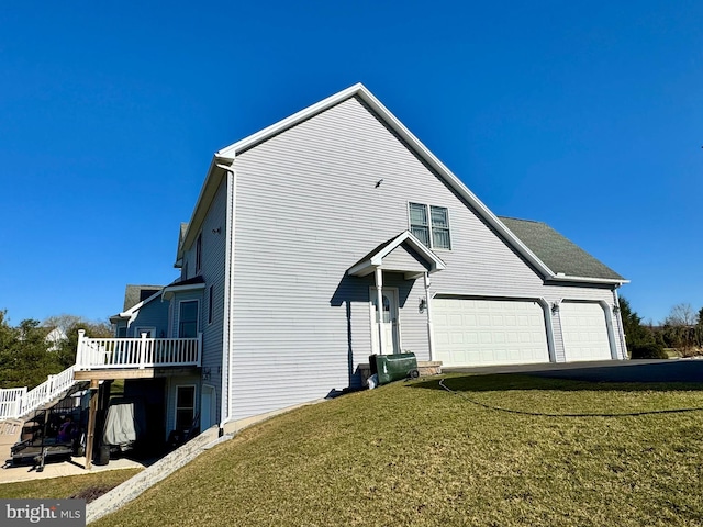 view of front of house featuring an attached garage, a front yard, a deck, and stairway