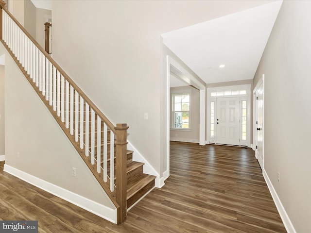 foyer with dark wood-style flooring, recessed lighting, stairway, and baseboards