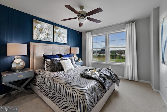 carpeted bedroom featuring baseboards and a ceiling fan