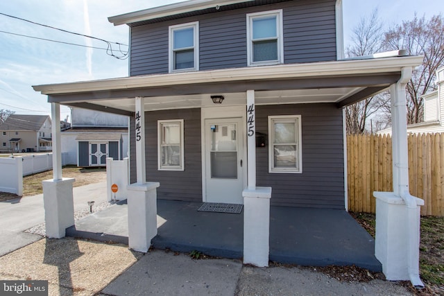 445 Blue Bell Rd, Williamstown, NJ 08094 - view of front of house with an outdoor structure, a porch, fence, and a shed