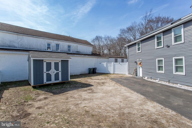 445 Blue Bell Rd, Williamstown, NJ 08094 - rear view of property with an outbuilding, a storage unit, and fence