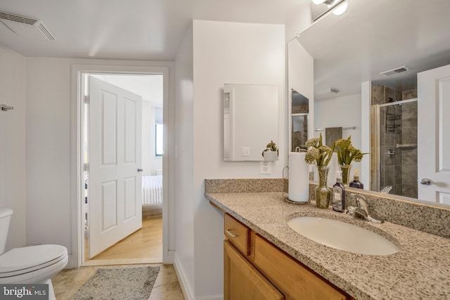 ensuite bathroom with tile patterned flooring, vanity, toilet, a stall shower, and visible vents