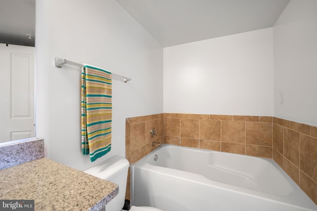 bathroom with a bath, toilet, and vanity