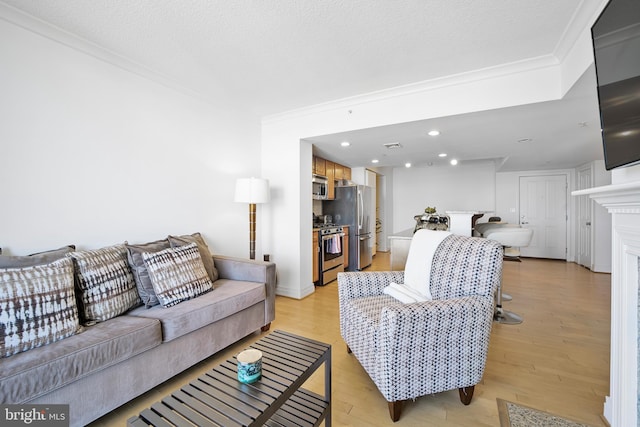 living area with light wood-type flooring, recessed lighting, ornamental molding, and a fireplace