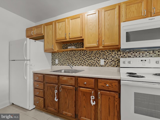 kitchen with white appliances, a sink, light countertops, tasteful backsplash, and light tile patterned floors