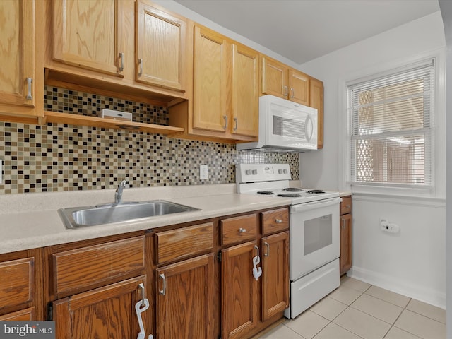 kitchen with white appliances, a sink, light tile patterned floors, open shelves, and light countertops