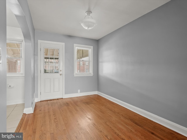 entryway featuring baseboards and light wood-type flooring